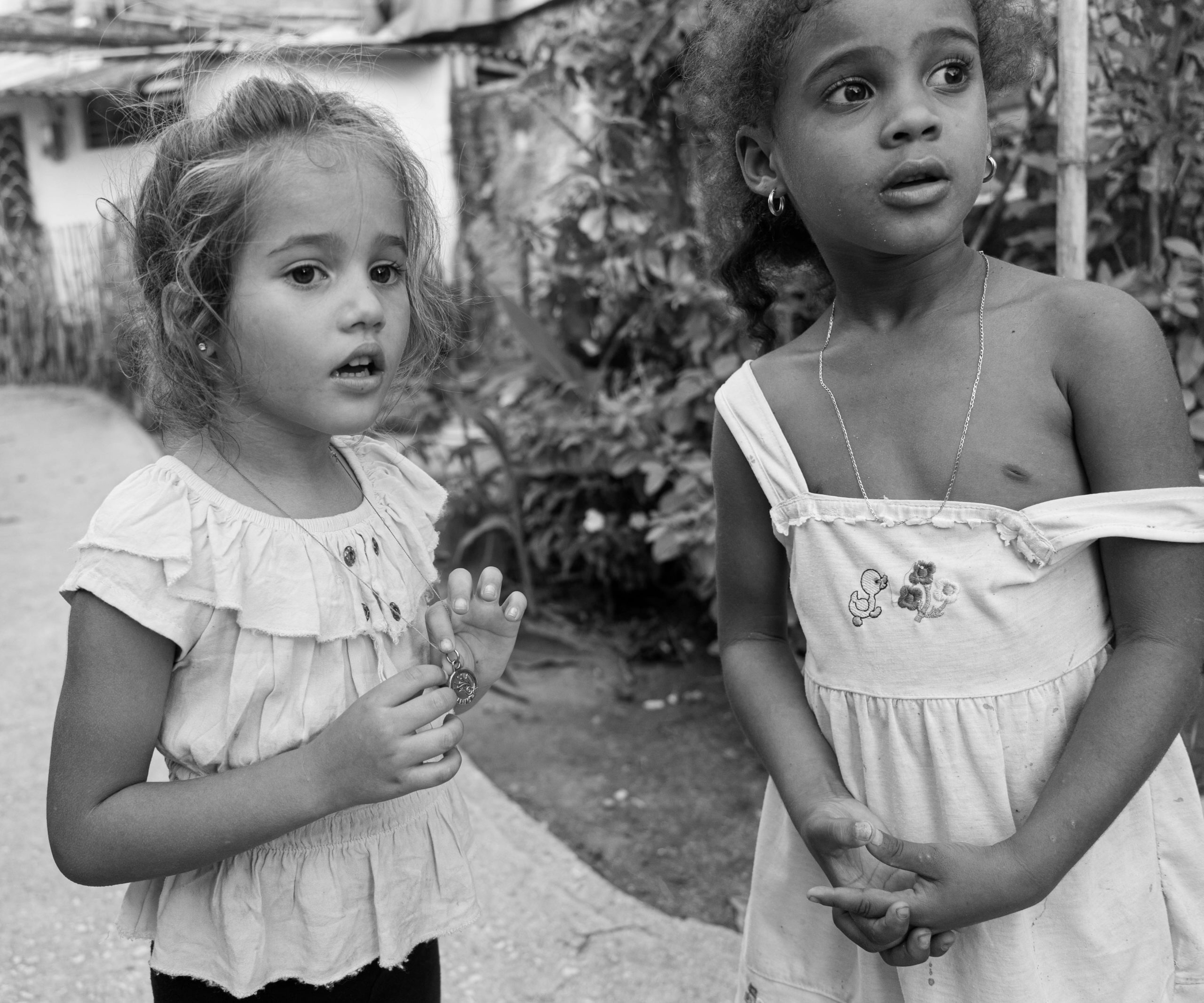 Two girls in front of their apartment building in Sancti Spiritus, Cuba. © 2022 John D. Elliott • www.TheHumanPulse.com