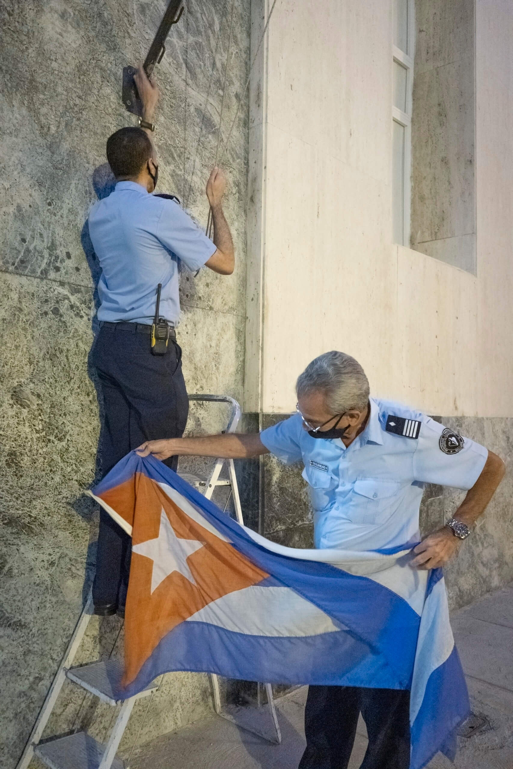 Military guards in the Habana Vieja district of the capital remove the Cuban flag at the end of the day. Penitents outside the Church of San Lazaro near Havana. © 2022 John D. Elliott • www.TheHumanPulse.com