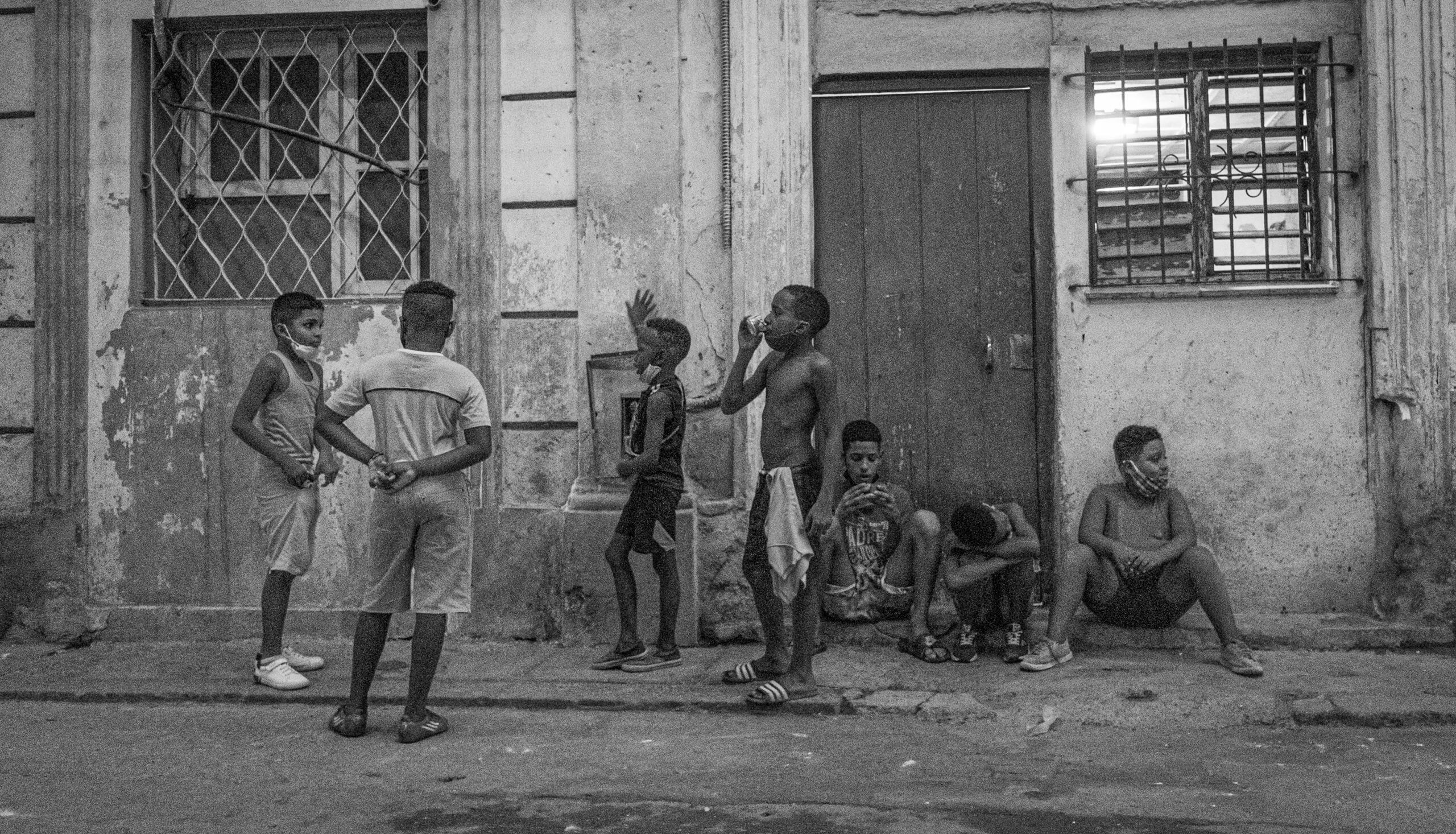 Boys congregate at dusk. Cubans continue to struggle under adverse economic conditions, as evidenced by this scene in the Habana Centro district of the capital. © 2022 John D. Elliott • www.TheHumanPulse.com