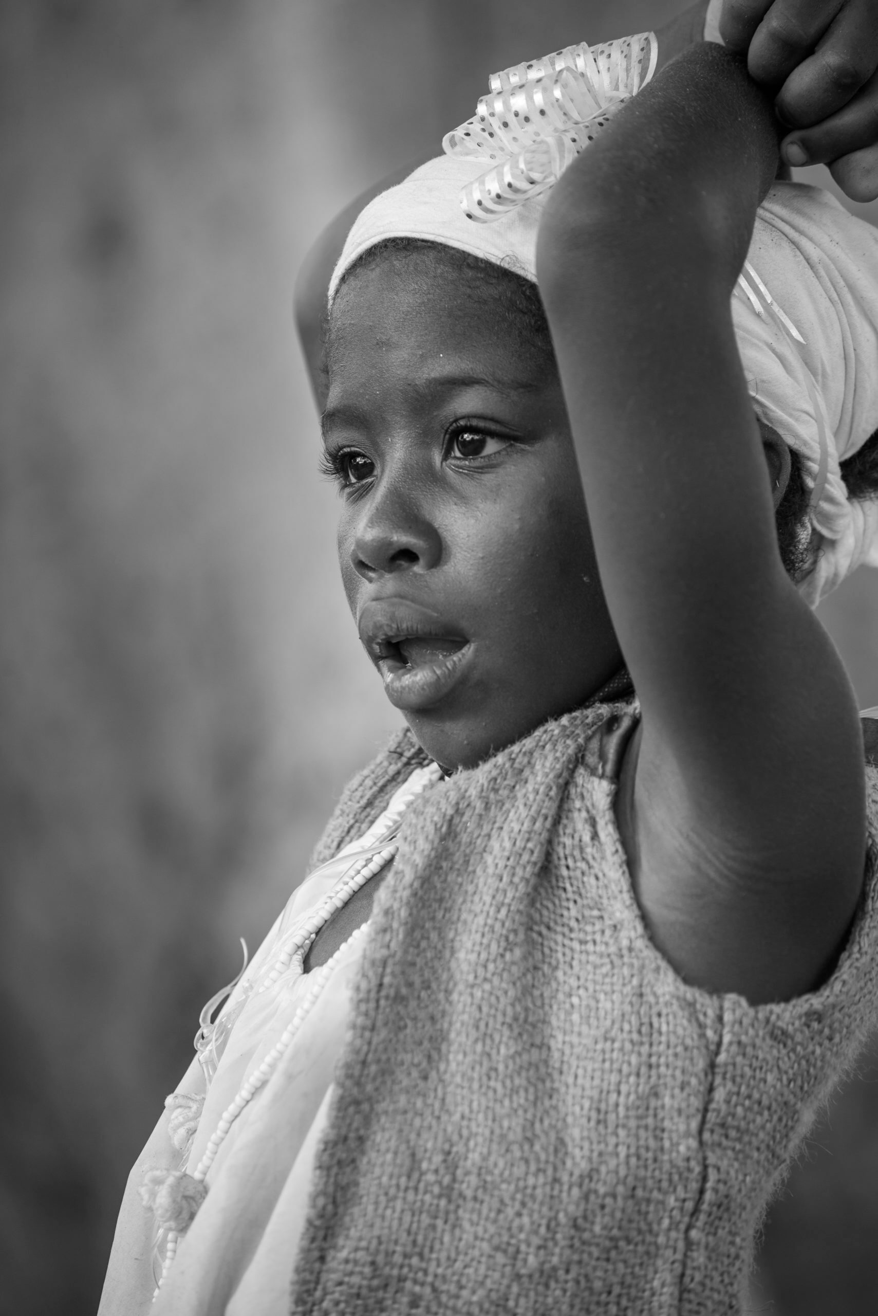 Cuban children, such as this girl outside the Church of San Lazaro, sometimes doff their "nasobuco," or facemask. © 2022 John D. Elliott • www.TheHumanPulse.com